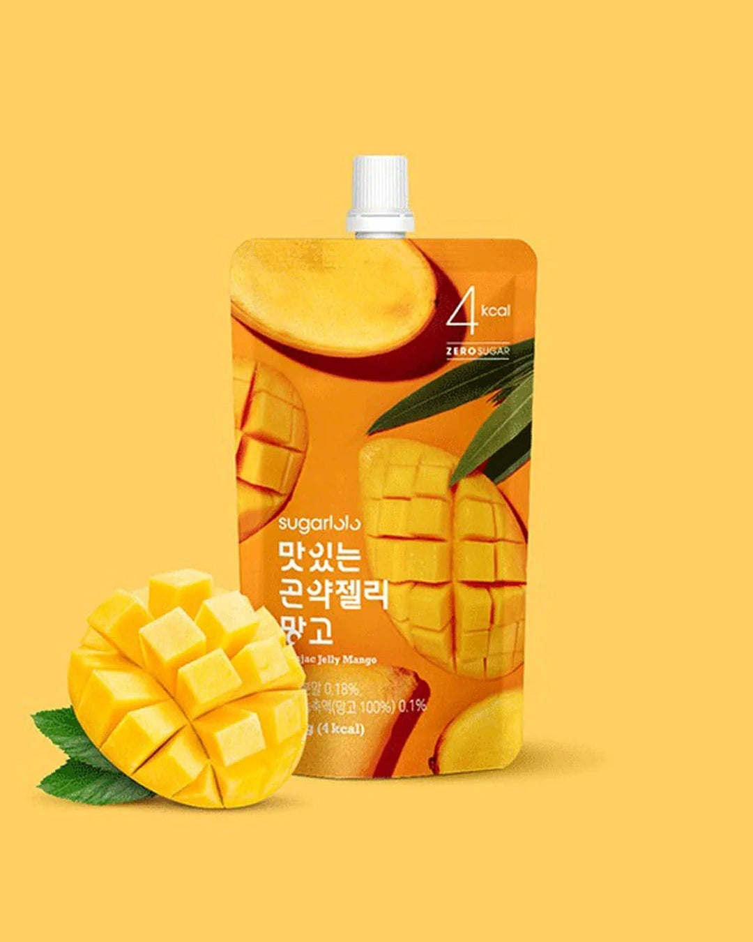 A stand-up pouch of sugartar Jelly Mango drink with a white cap, shown on a warm yellow background with a sliced mango and green leaves in front. The pouch is orange with mango graphics and Korean text.