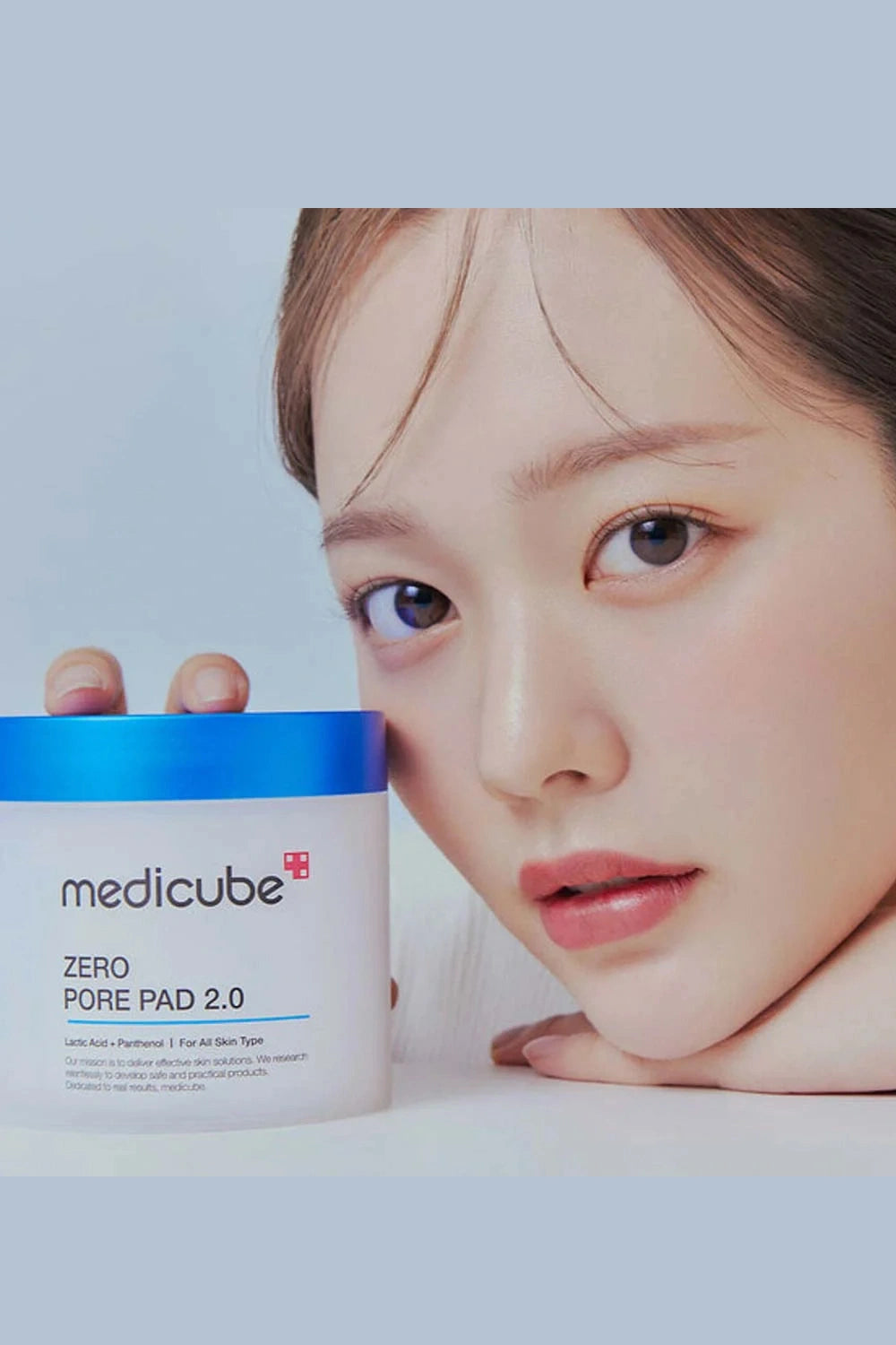 Medicube Zero Pore Pad 2.0 container with a person's face in the background