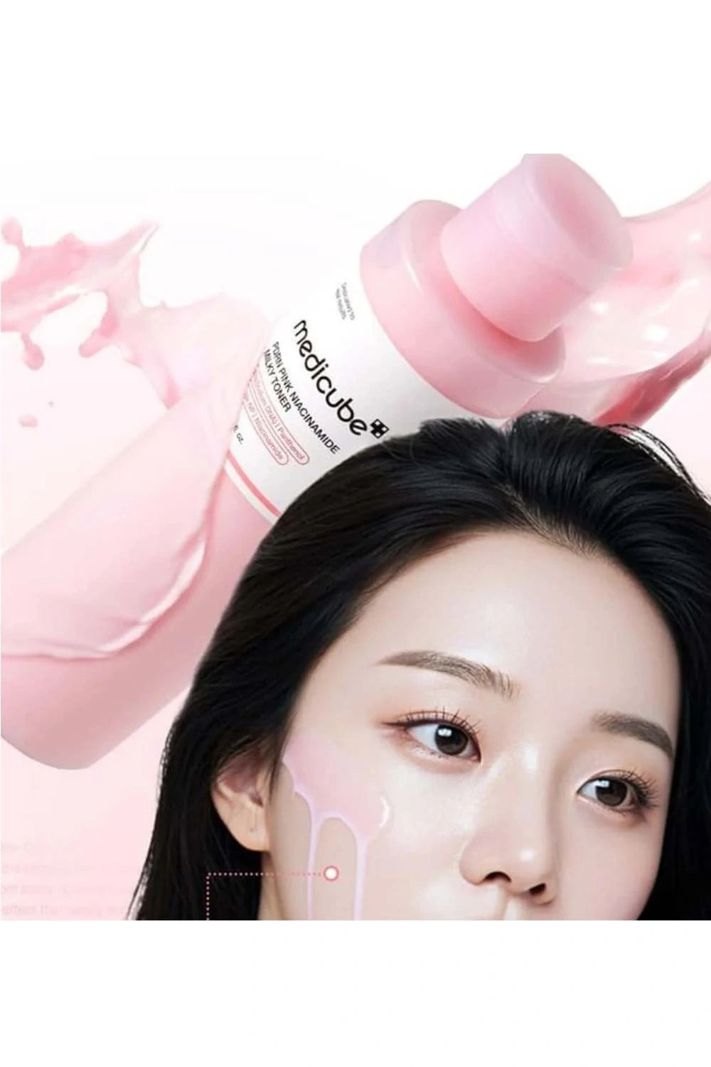 Woman with a pink bottle of skincare product on her face