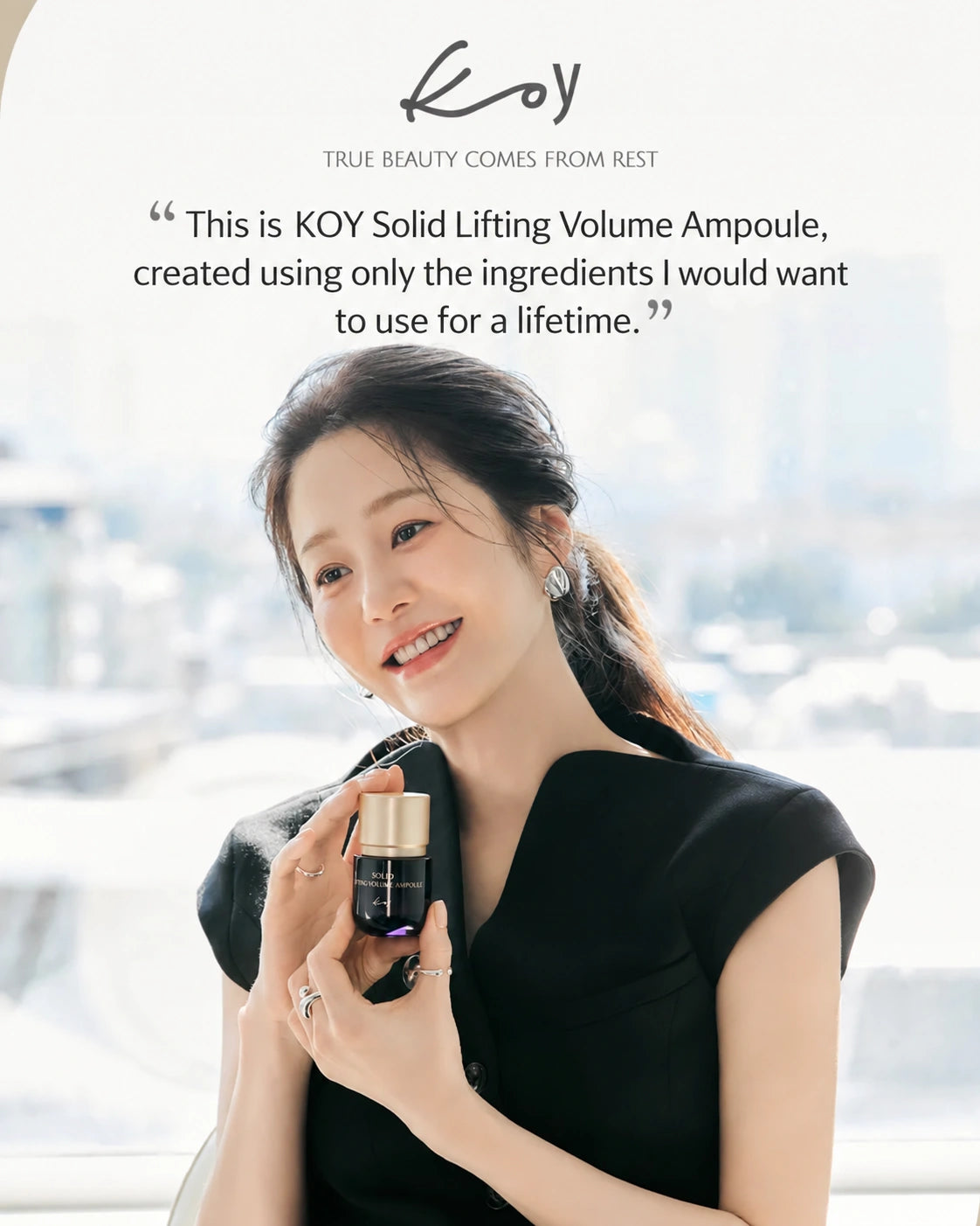 A woman in a black dress holds a small cosmetic ampoule bottle with a gold cap in front of a bright window. The image includes the brand name KOY at the top and a quote about the product.