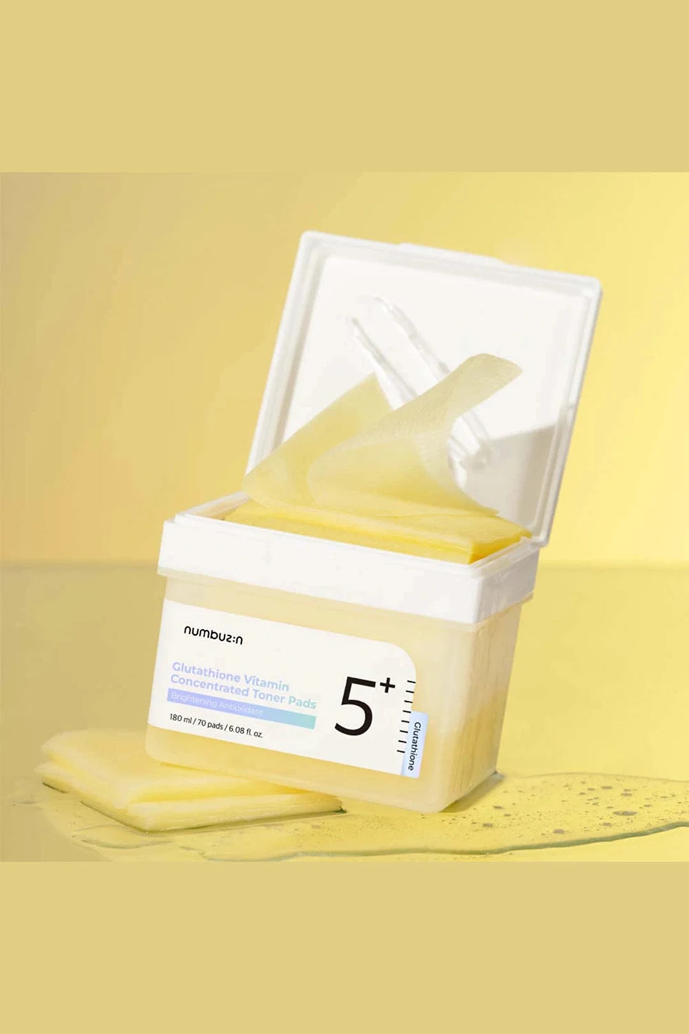 Cosmetic product with a white lid on a yellow background