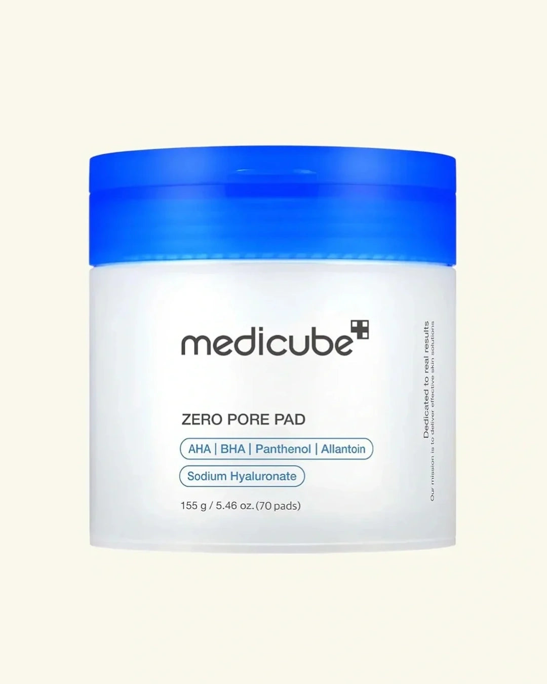 A white jar of Medicube Zero Pore Pad with a bright blue screw-on lid, centered on a light cream background.