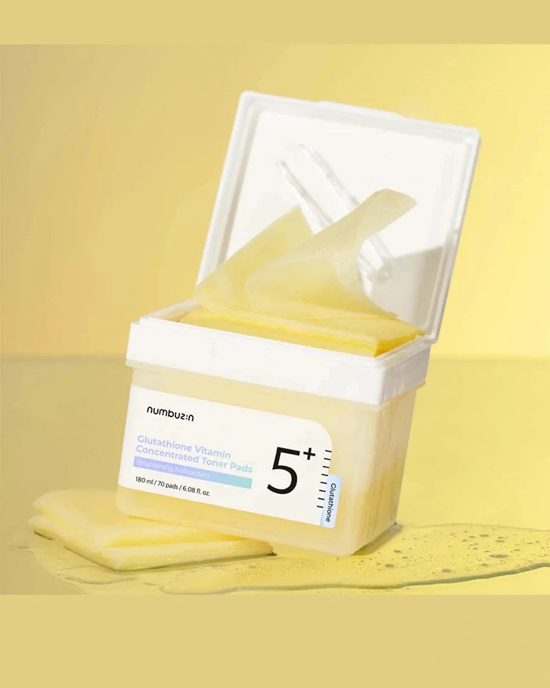 A tub of numbezn 5+ Glucosamine Vitamin Concentrated Nerve Patch with translucent yellow patches visible inside, set against a yellow background with a few patches placed in front.