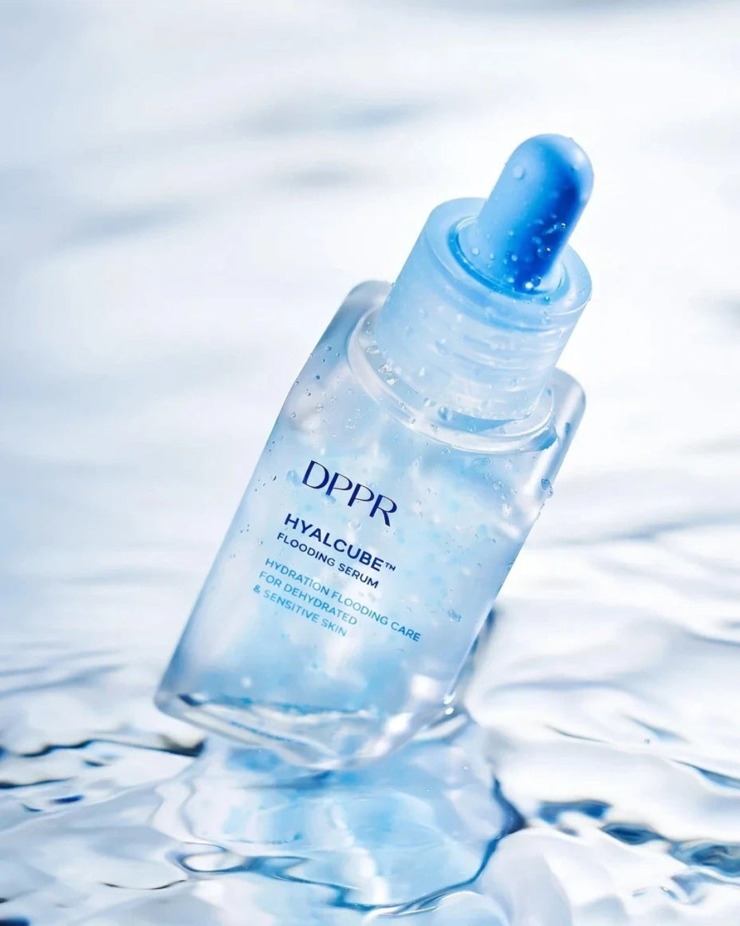 A clear dropper bottle of DPPR Hyalcure Flooding Serum floating on rippling water, with blue droplet details and a light blue tint.