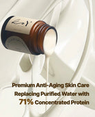 An amber glass skincare bottle labeled 'ko' with white cream being poured, set against a glossy white liquid background. Text at the bottom reads: 'Premium Anti-Aging Skin Care Replacing Purified Water with 71% Concentrated Protein'.