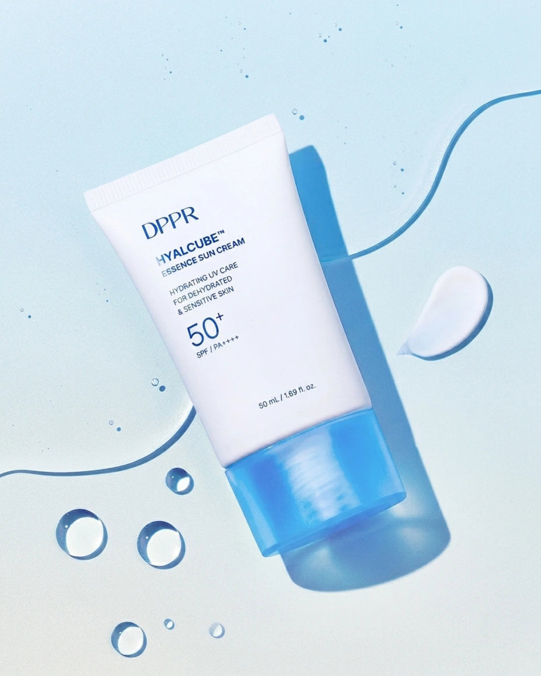 DPDR Hyalcube Intensive Sun Cream SPF 50+ in a white squeeze tube with a translucent blue cap, set against a light blue background with water droplets and a dollop of cream.