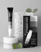 Daycell MBA MoBala hair restoration kit featuring a black and white applicator tube on a marble pedestal, its retail box, and a smaller product box, styled with green leaves on a gray background.