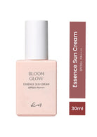 Bloom Glow Essence Sun Cream SPF50+ PA++++ in a pale pink rectangular bottle with a white cap, shown next to a vertical color swatch strip indicating the shade as 'Essence Sun Cream' and '30ml'.