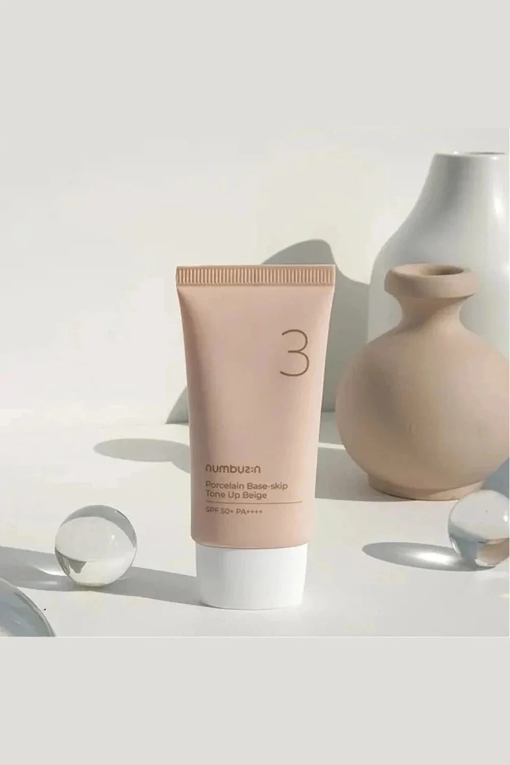 Tube of sunscreen with a neutral background