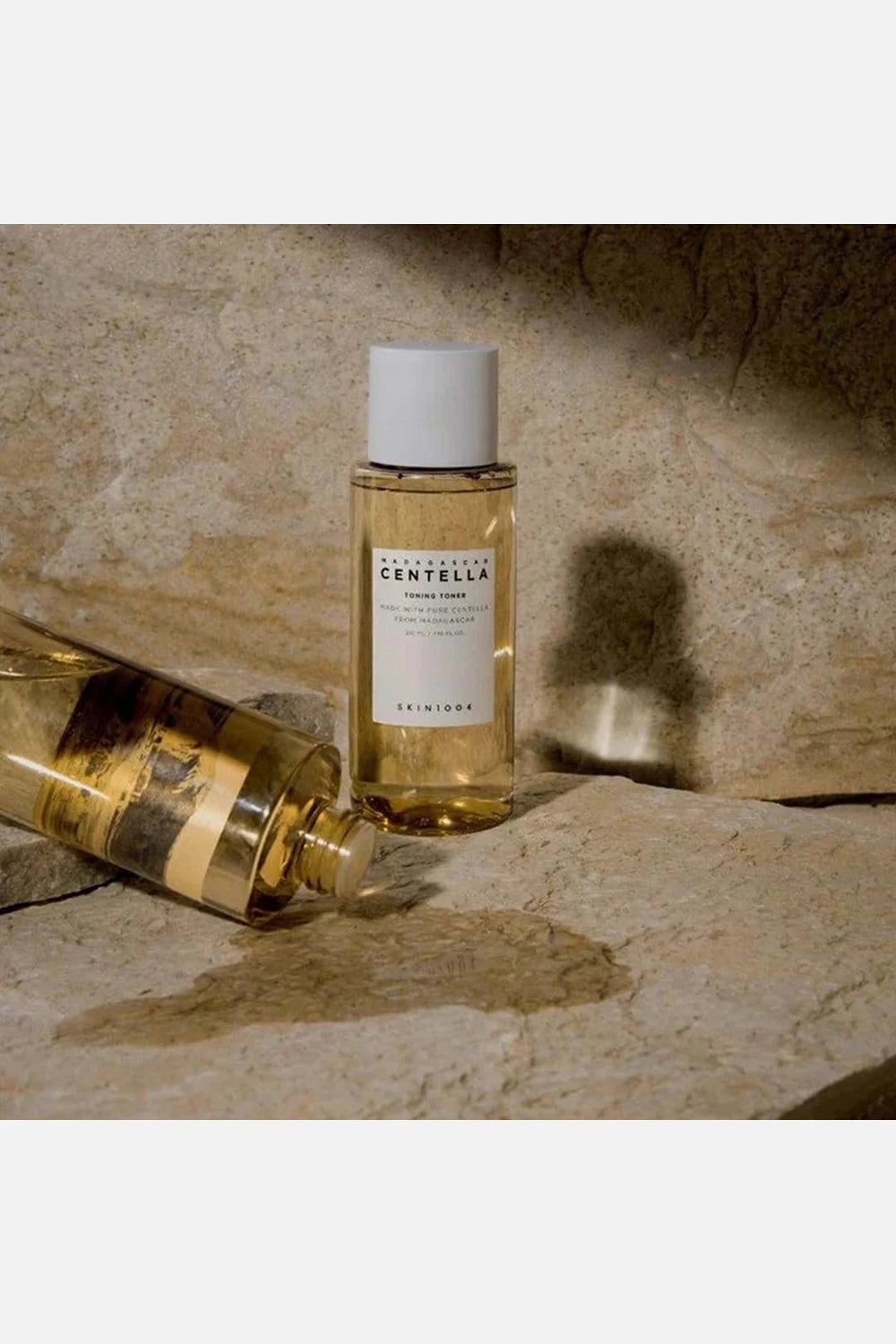 Bottle of Centella on a stone surface