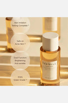 Skincare bottle with gold cap and white label on a reflective gold background