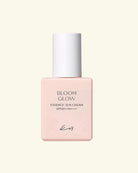 A bottle of Koy Bloom Glow Essence Sun Cream SPF50+ PA+++ in a soft pastel pink bottle with a white cap, centered on a light cream background.