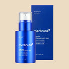 Blue Medicube skincare product bottle and packaging on a beige background