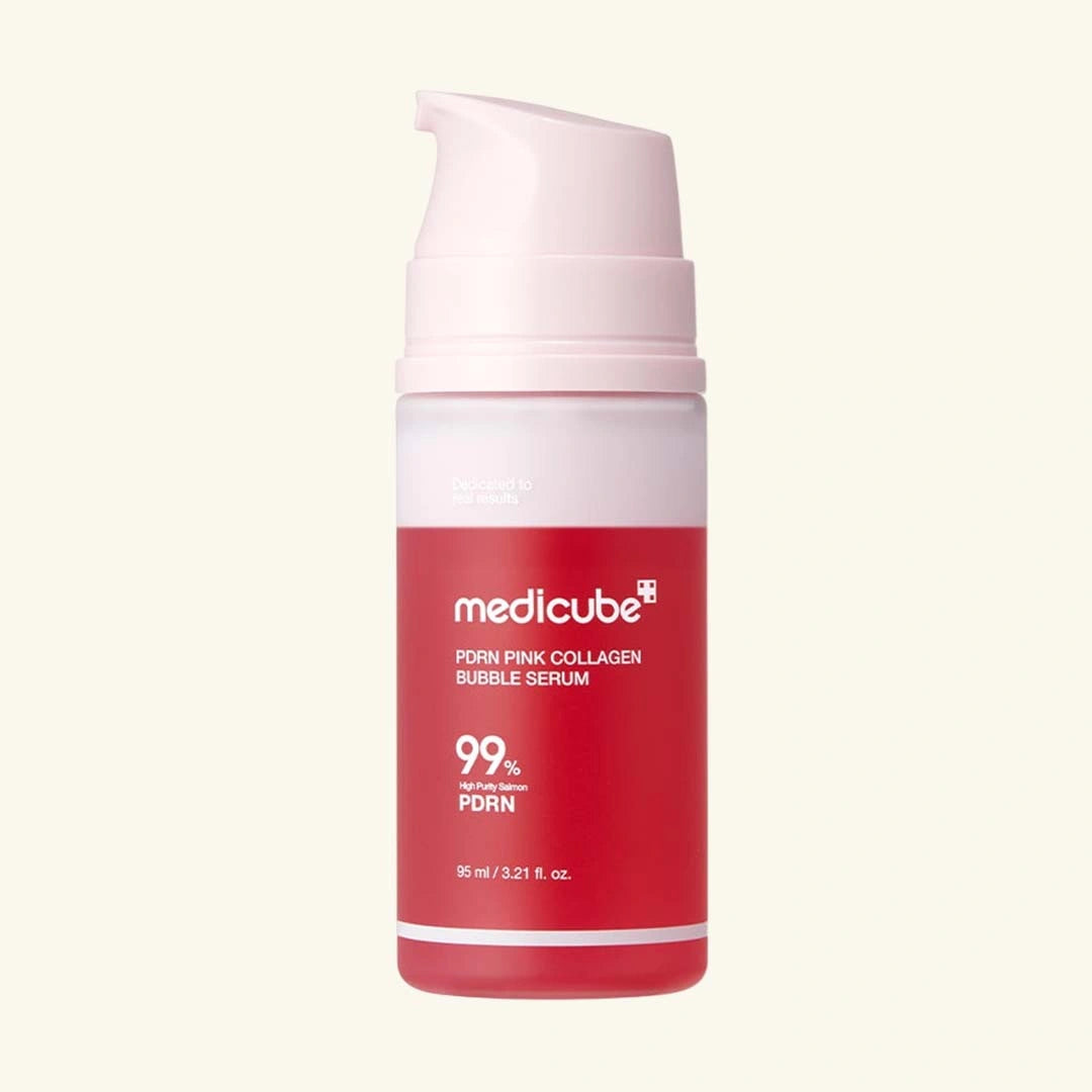 Red skincare serum bottle with pink cap on a light beige background