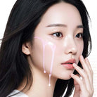 Close-up of a person with a hand near their face on a white background