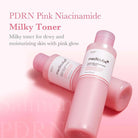 Pink Niacinamide Milky Toner bottle with text on a pink background
