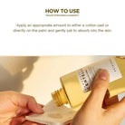 Gold bottle being applied to a cotton pad with text on how to use it.