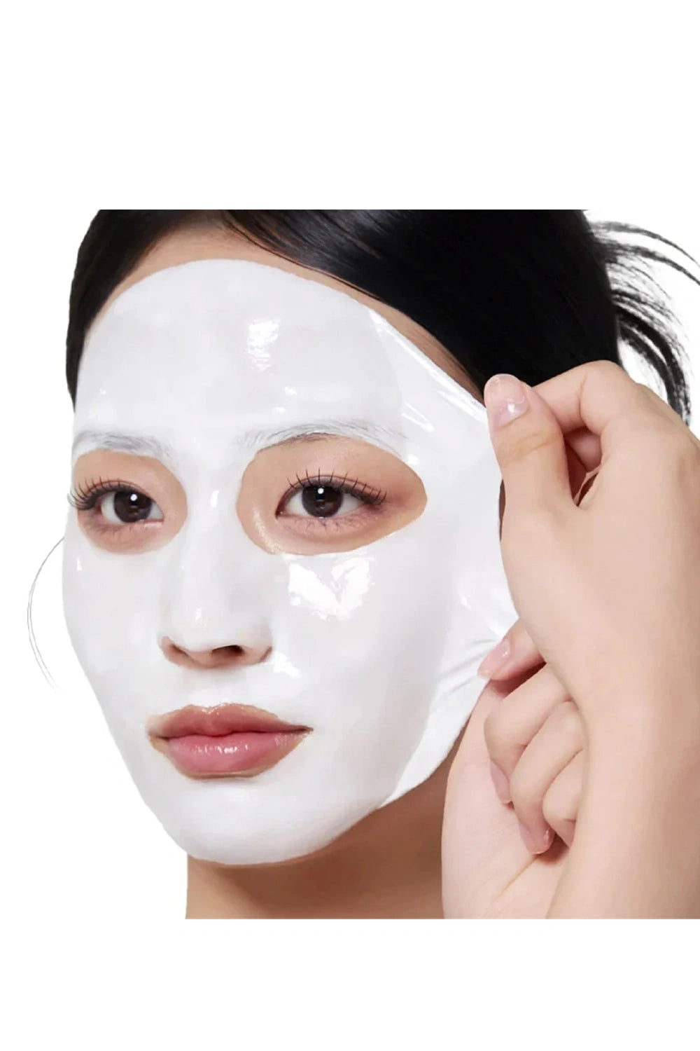 Person applying a white face mask with a hand on a white background