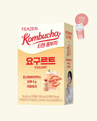 A box of TEAZEN Kombucha Yogurt on a light cream background, featuring red and black text, a pink promotional badge indicating a free plastic cup, and an illustration of a yogurt cup on the side panel.