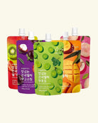 Five colorful stand-up pouches of sugarlab fruit drink mix arranged in a fan shape on a light cream background. The pouches feature different fruit illustrations and Korean text, including red strawberry, purple passionfruit, green grape, orange mango, and pink peach flavors.
