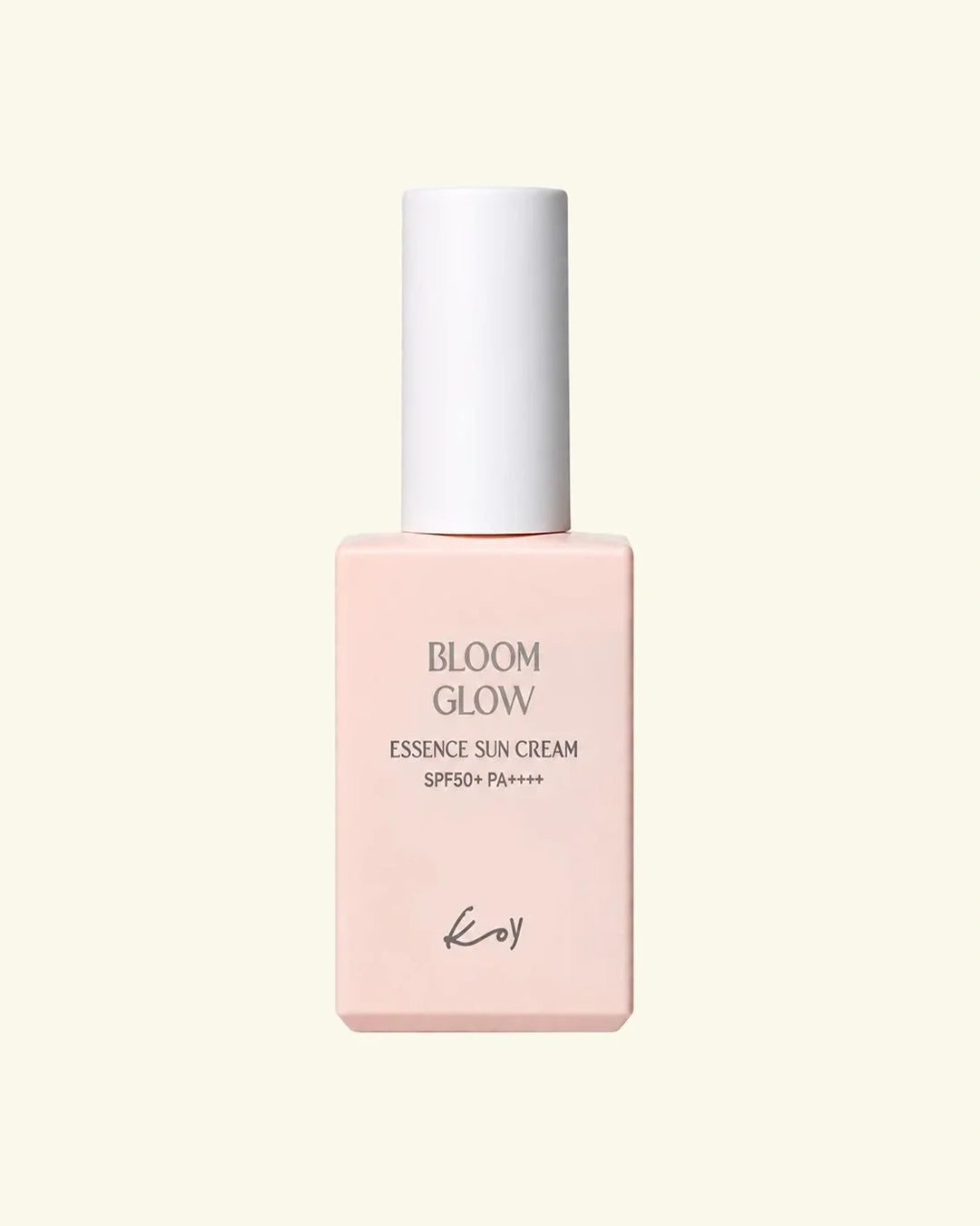 A bottle of Koy Bloom Glow Essence Sun Cream SPF50+ PA+++ in a soft pastel pink shade with a white cap, centered on a light cream background.