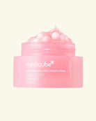 A pink cosmetic jar labeled medicube+ PORN PINK COLLAGEN CAPSULE CREAM, shown open with pink cream and capsules visible on a pale cream background.
