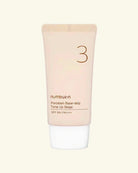 A squeeze tube of numbu:n Porcelain Base-skip Tone Up Beige SPF 50+ PA+++ sunscreen, featuring a pale peach-beige body with a white cap, centered on a light cream background.
